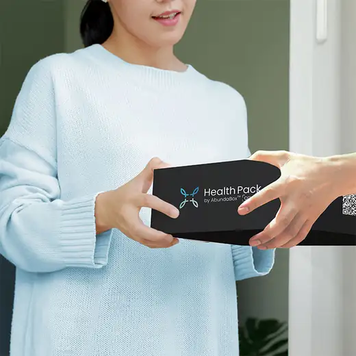A member holding a delivered AbundaBox HealthPack
